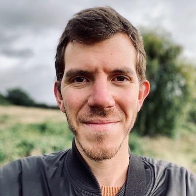 Selfie of Chris Mytton standing in a field with a slightly blurred background